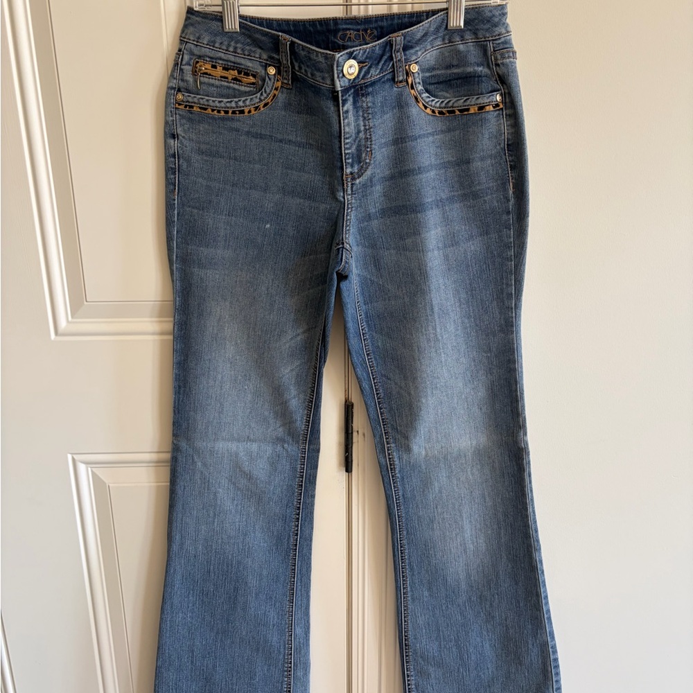 Cache Stylish Blue Jeans with Cheetah trim on front and back pockets.